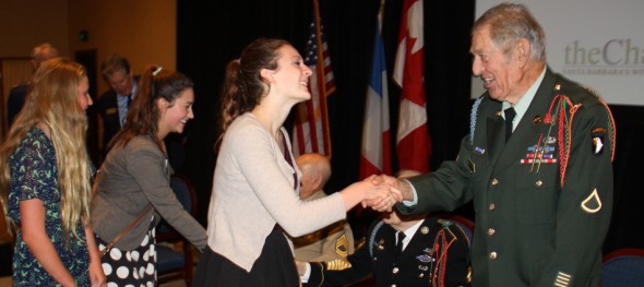 Lia Millar, a junior at Anacapa School, greets Art Petersen, who was a U.S. Army paratrooper on D-Day.