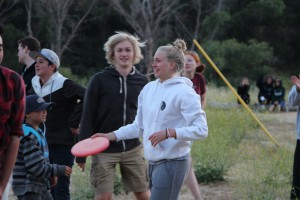 Anna, 11th grade, plays frisbee with fellow students.