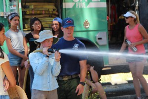 Leah, 7th grade, gets to see what its like to spray the fire hose.