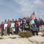 Group with flag mountain top